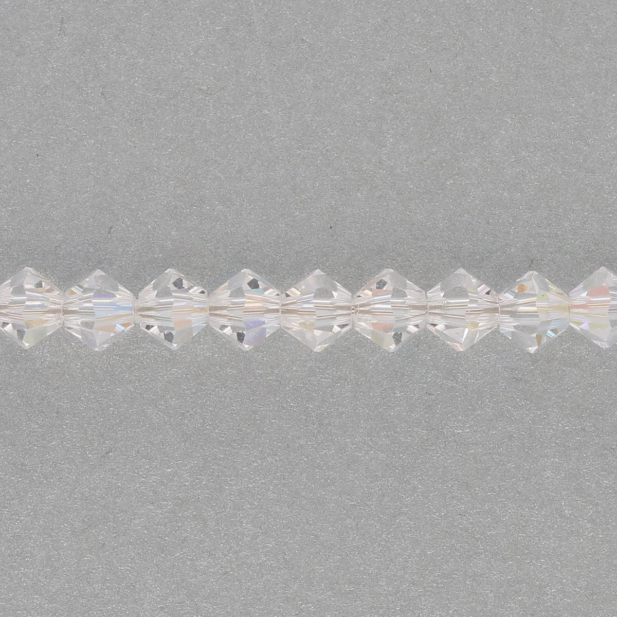 M.C. Doppelkegel 4 mm - Crystal AB - PerlineBeads SA