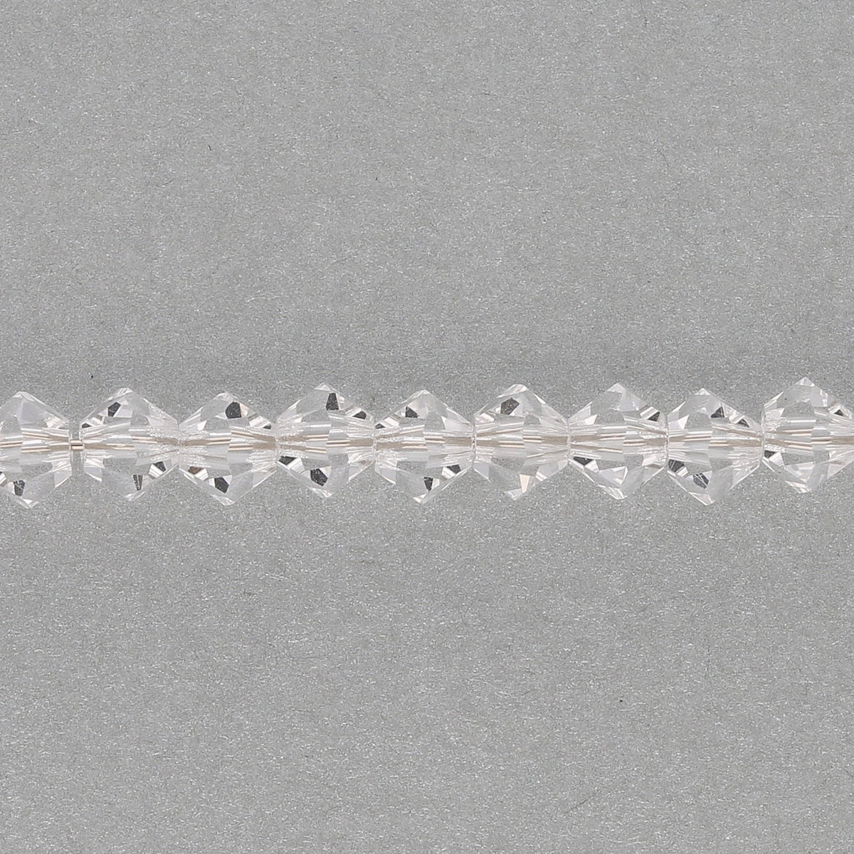 M.C. Doppelkegel 4 mm - Crystal - PerlineBeads SA