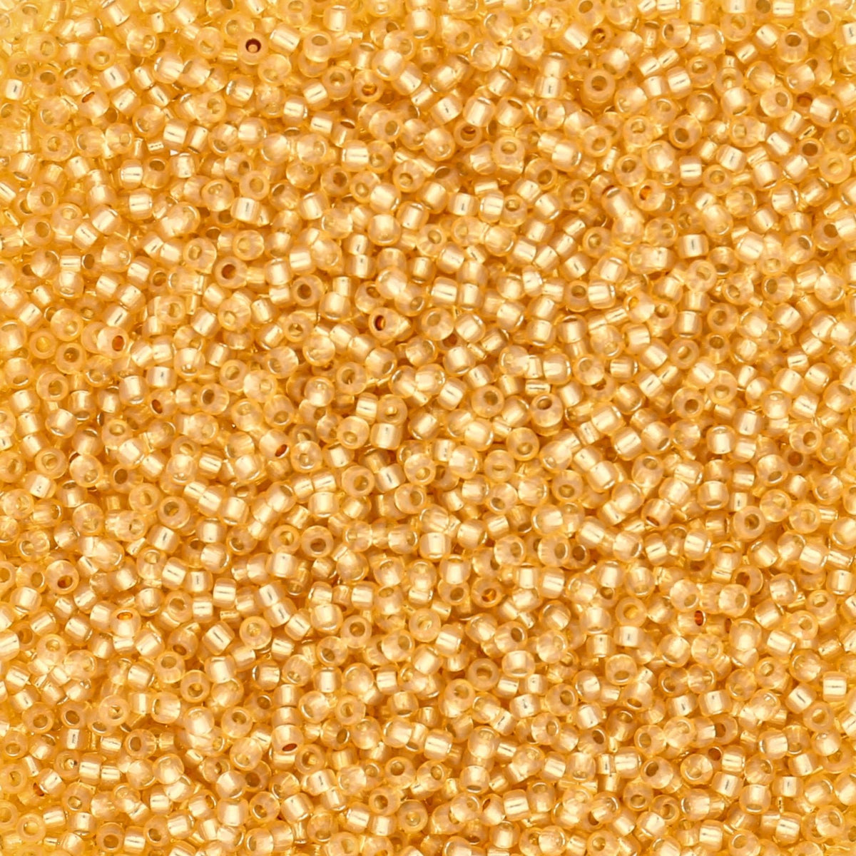 Rocailles-Perlen Toho 15/0 – Silver-Lined Milky Light Topaz - PerlineBeads