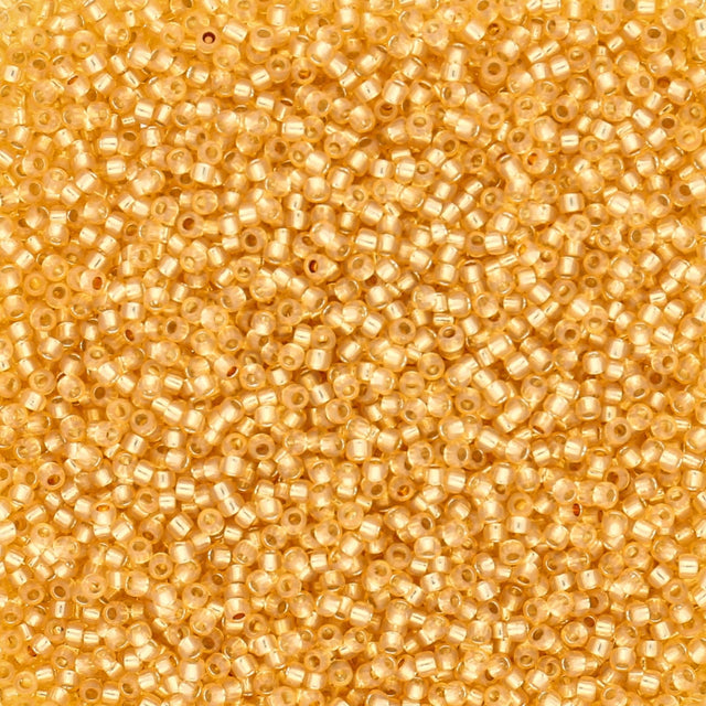 Rocailles-Perlen Toho 15/0 – Silver-Lined Milky Light Topaz - PerlineBeads